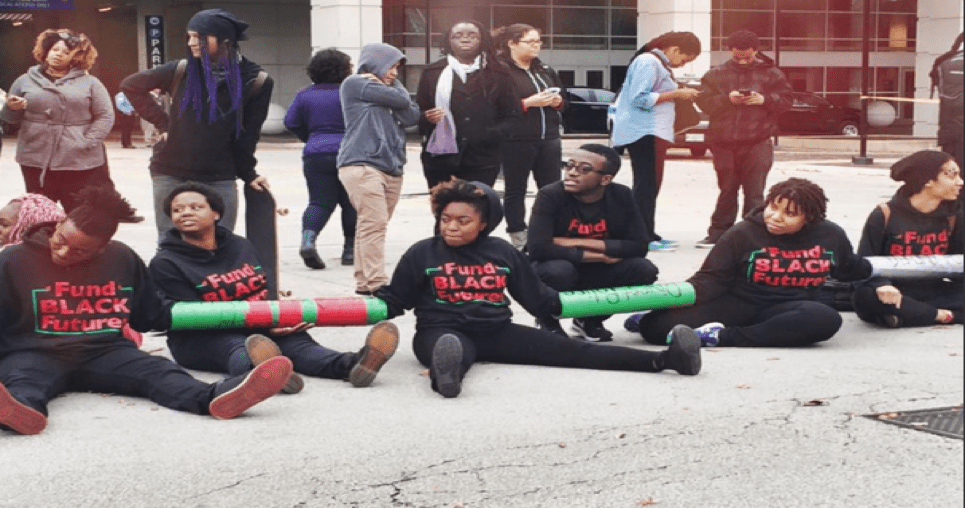 Charlene Carruthers, national director of BYP 100 (center) with other activists protesting the International Association of Chiefs of Police (IACP) Conference in Chicago in October of 2015. Photo Credit – BYP 100 Twitter Page